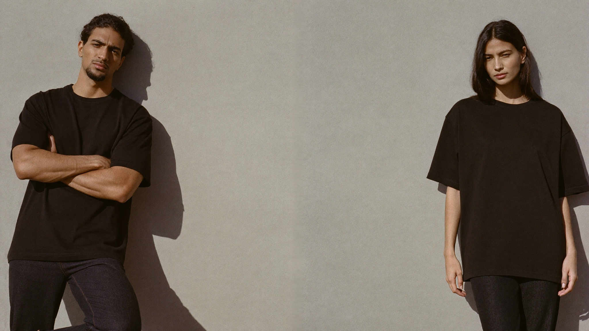NovaKart hero - two models in plain black oversized tees leaning against a concrete wall